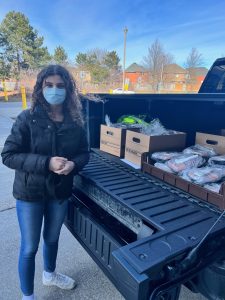 Samantha beside truck with deliveries