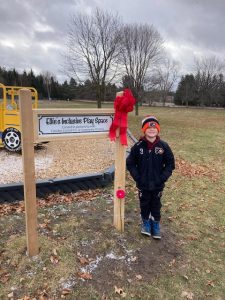 Dylan Miller, beside sign